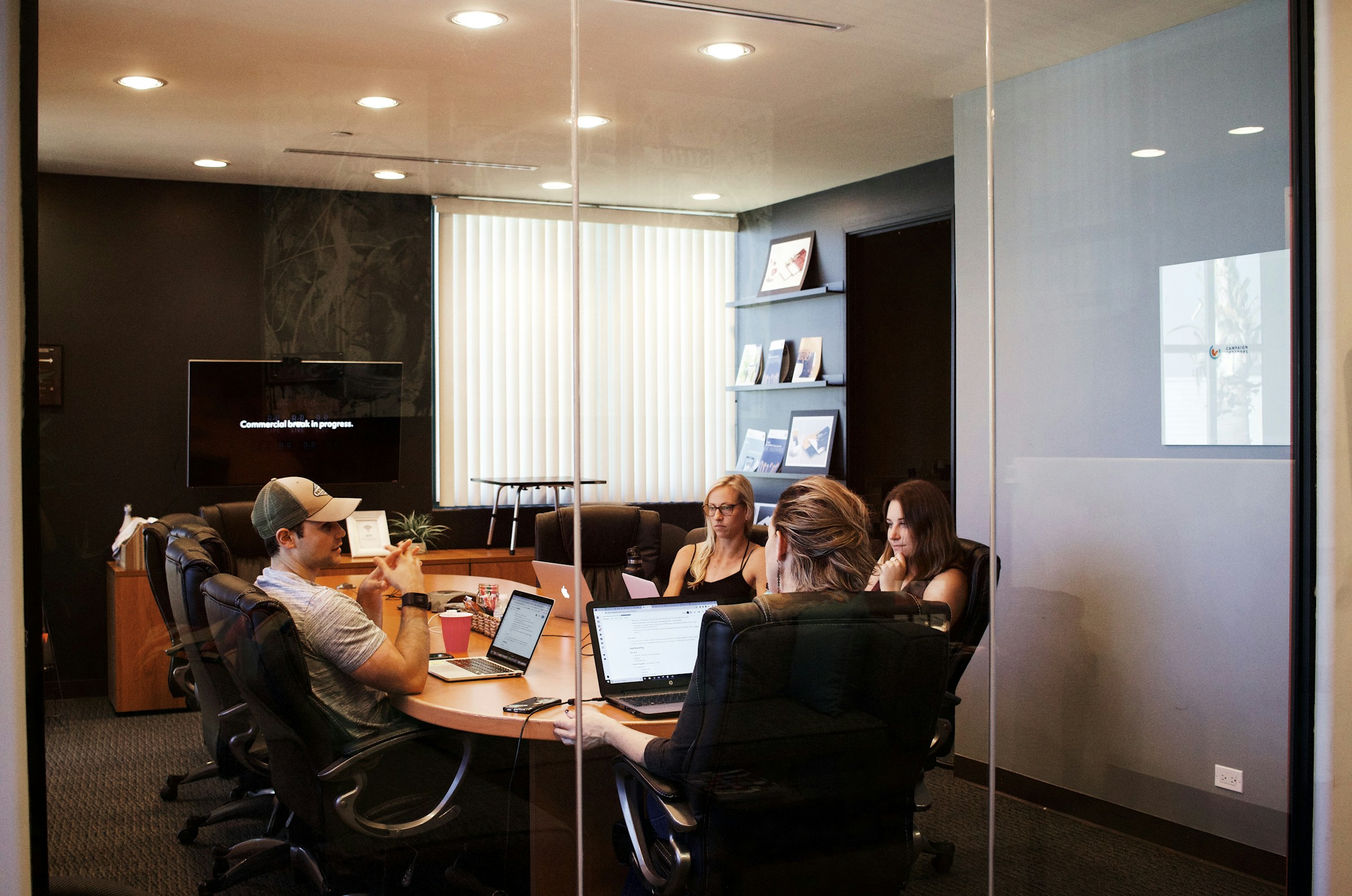 Team collaborating around a laptop