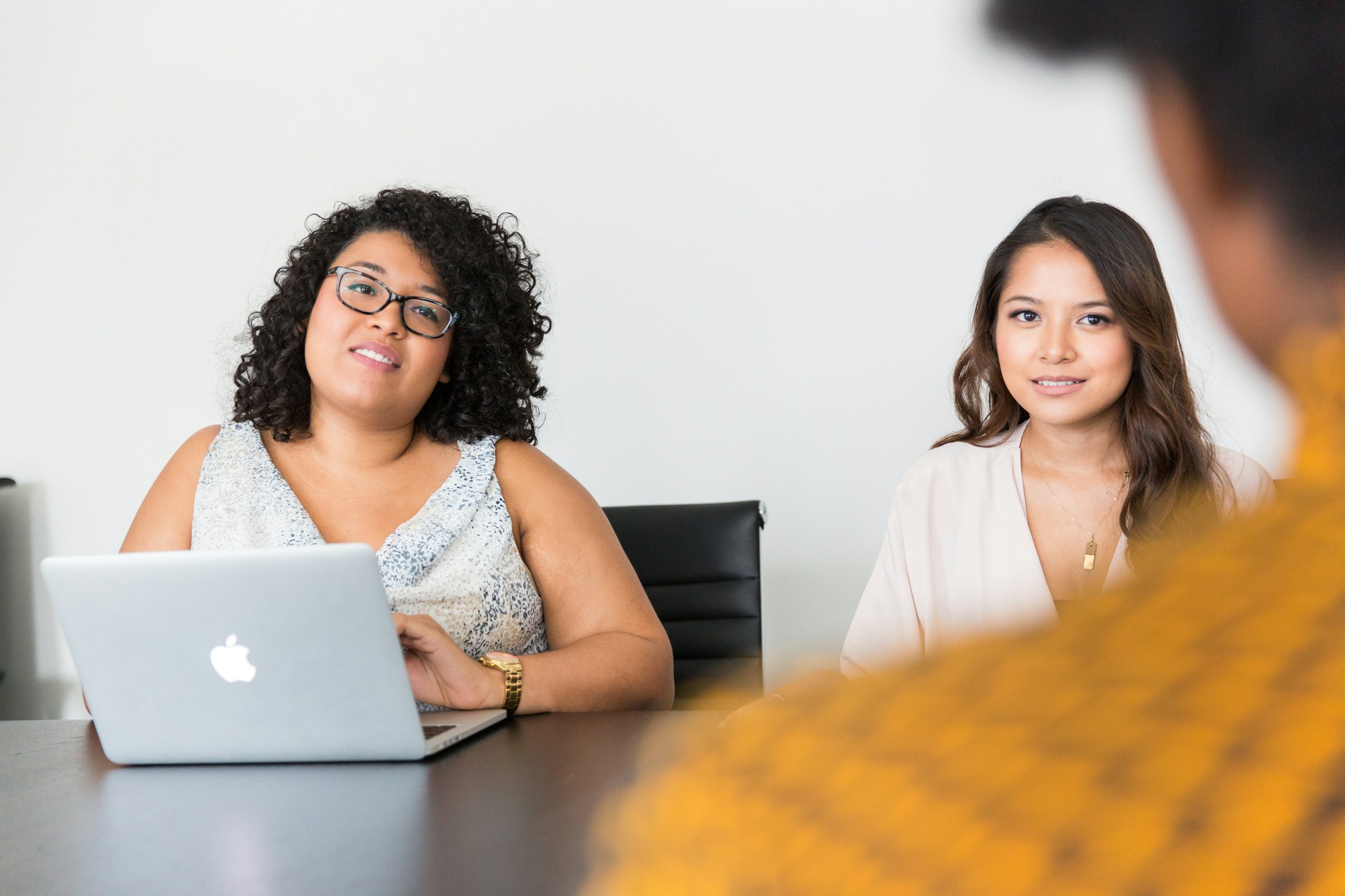 Two colleagues listening during a technical sales conversation